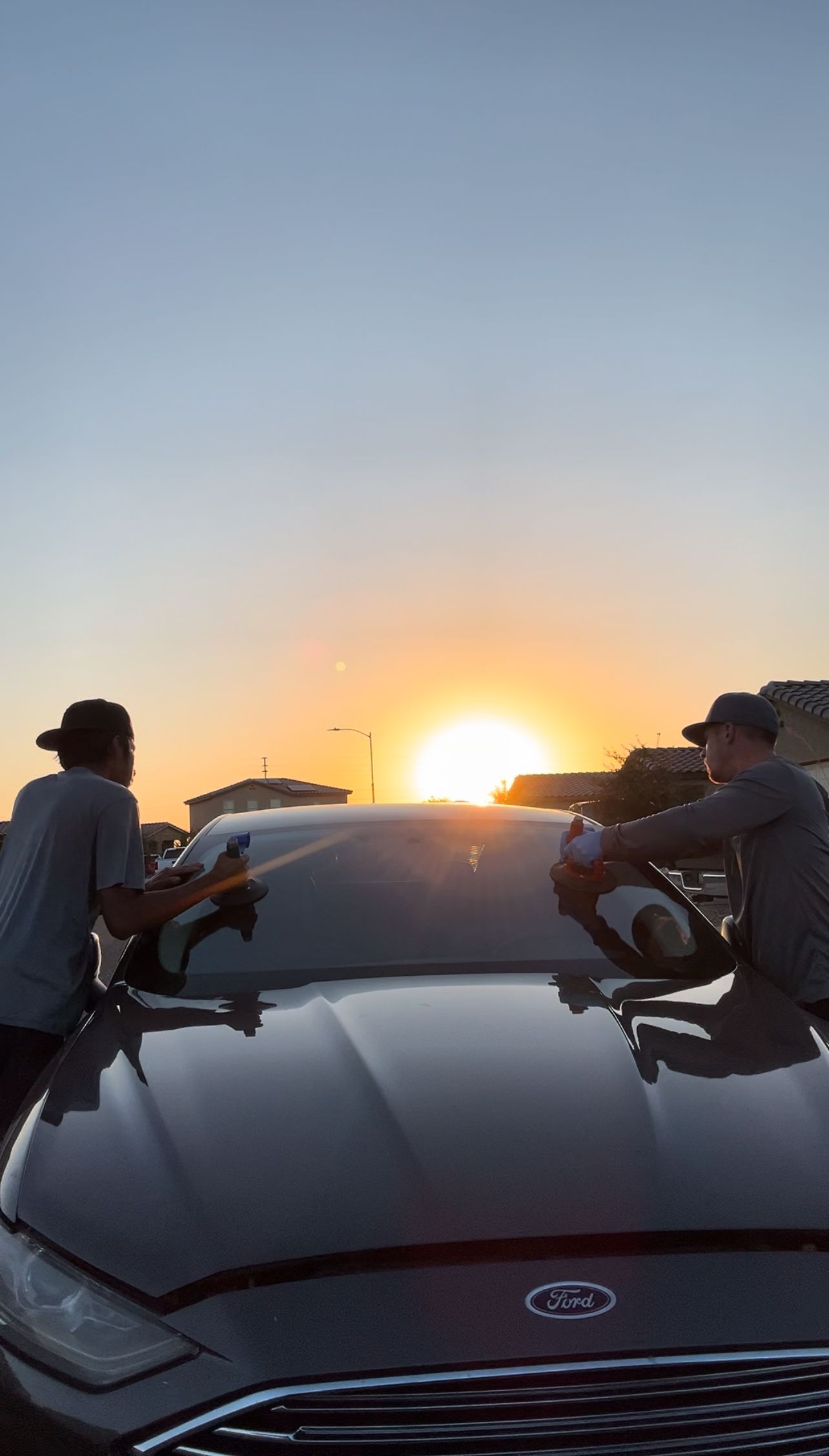 Windshield replacement at sunrise on a Ford car.