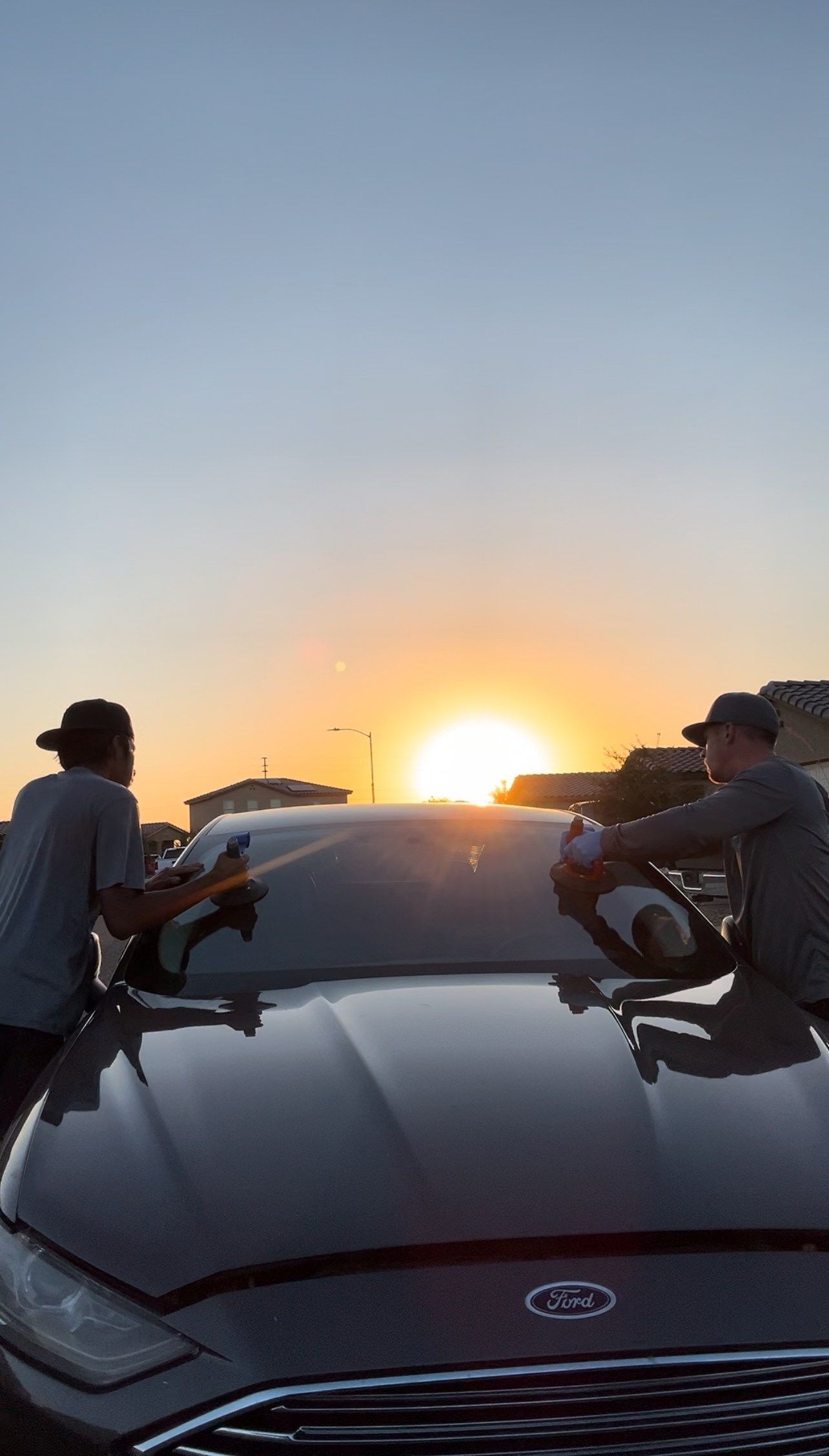 Windshield replacement at sunrise on a Ford car.