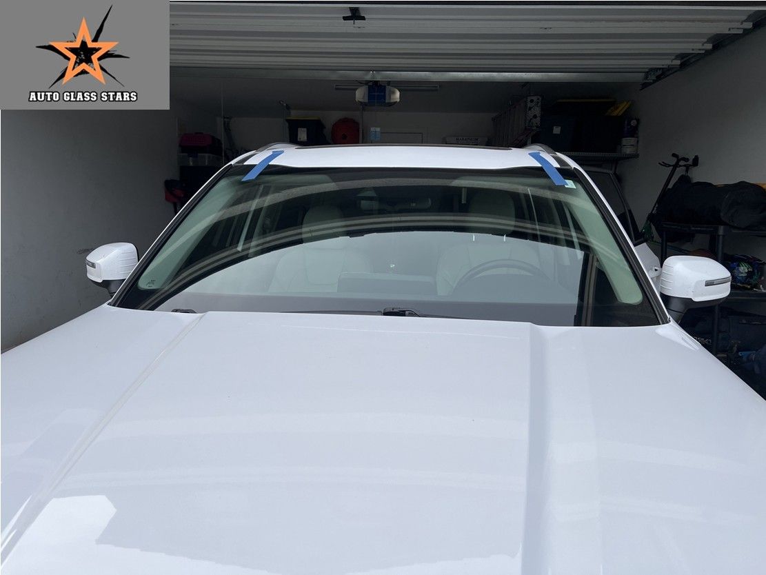 Windshield replacement on a white vehicle.