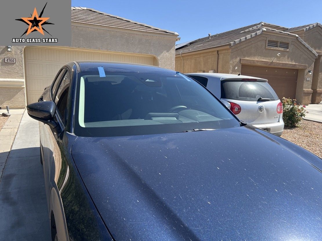 New OEM windshield installed on a Mazda at customer's home.