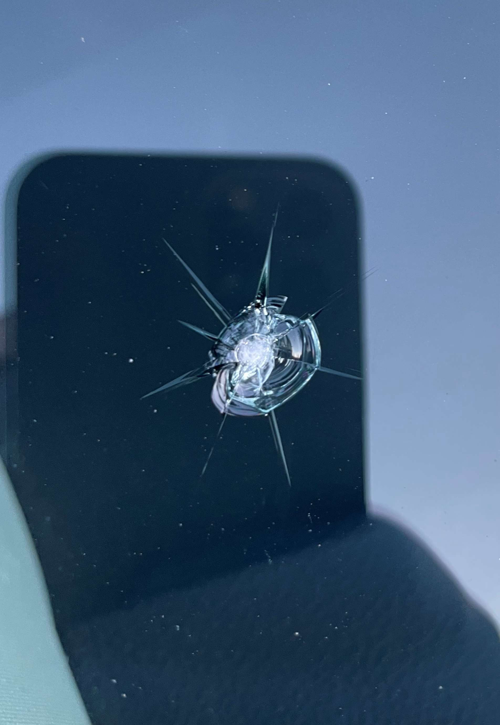 Windshield chip from a rock that cracked the glass.