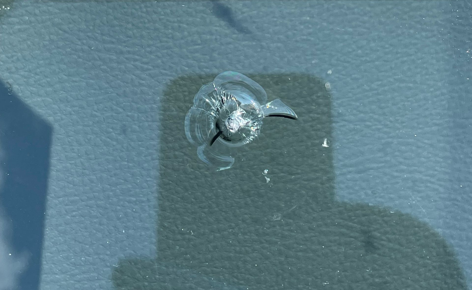 Windshield chip with a bullseye impact damage.