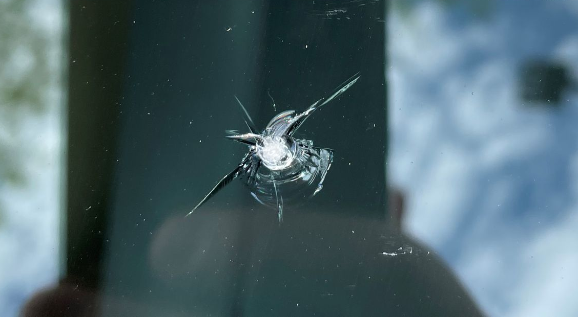 Cracked windshield chip before repair.