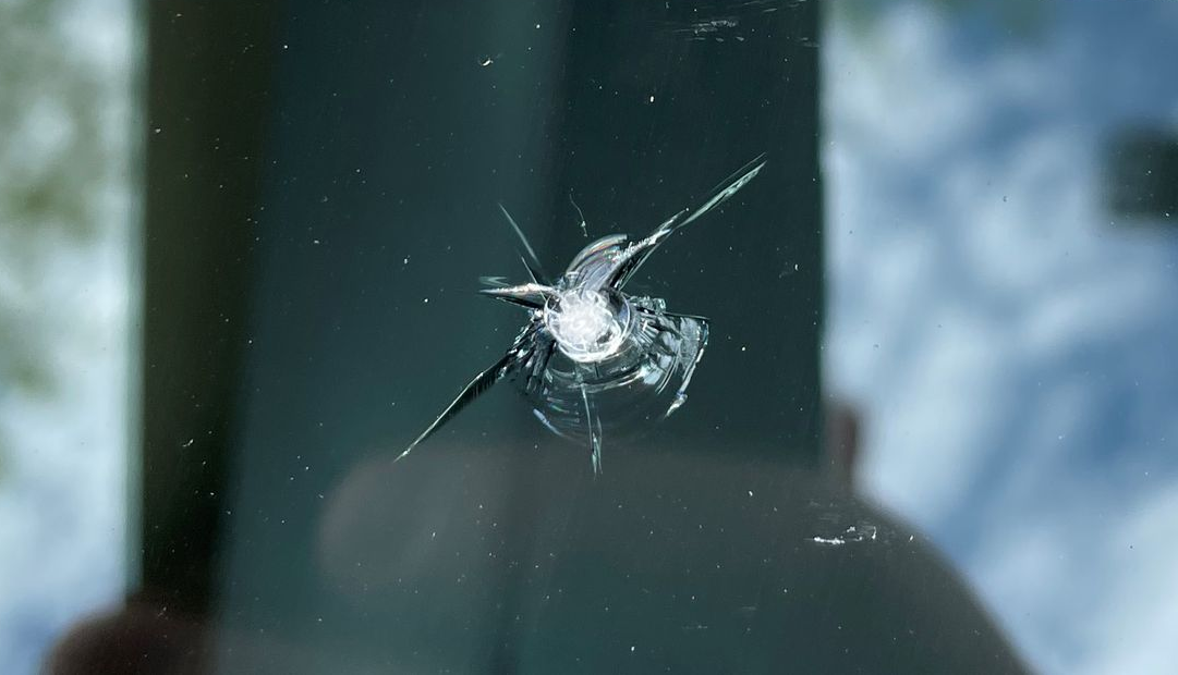 Windshield rock chip before repair.