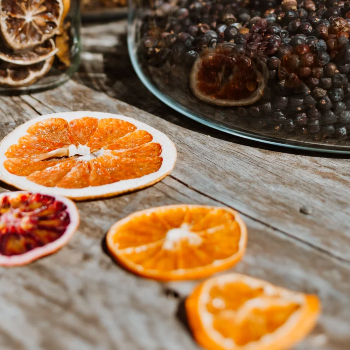 Slices of oranges and grapes on a wooden table