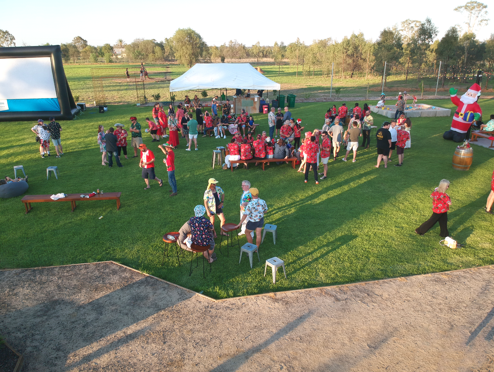 A large group of people are gathered in a grassy field.