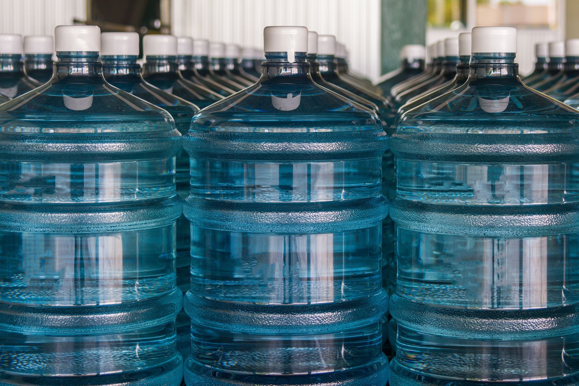 A row of water bottles stacked on top of each other.