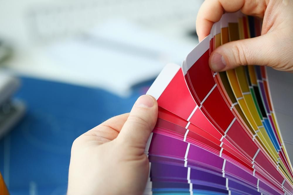 A Person Is Holding A Palette Of Colors In Their Hands — Paint & Trade Supplies Lismore In Bangalow, NSW