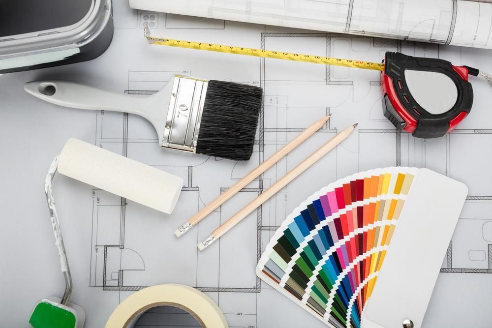 A Paint Brush, Tape Measure, Pencils, And A Fan Are Sitting On Top Of A Blueprint — Paint & Trade Supplies Lismore In Evans Head, NSW