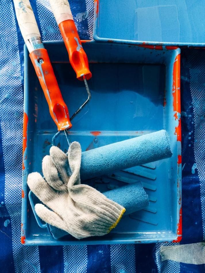 A Pair Of Gloves Sitting On Top Of A Blue Paint Tray — Paint & Trade Supplies Lismore In Goonellabah, NSW