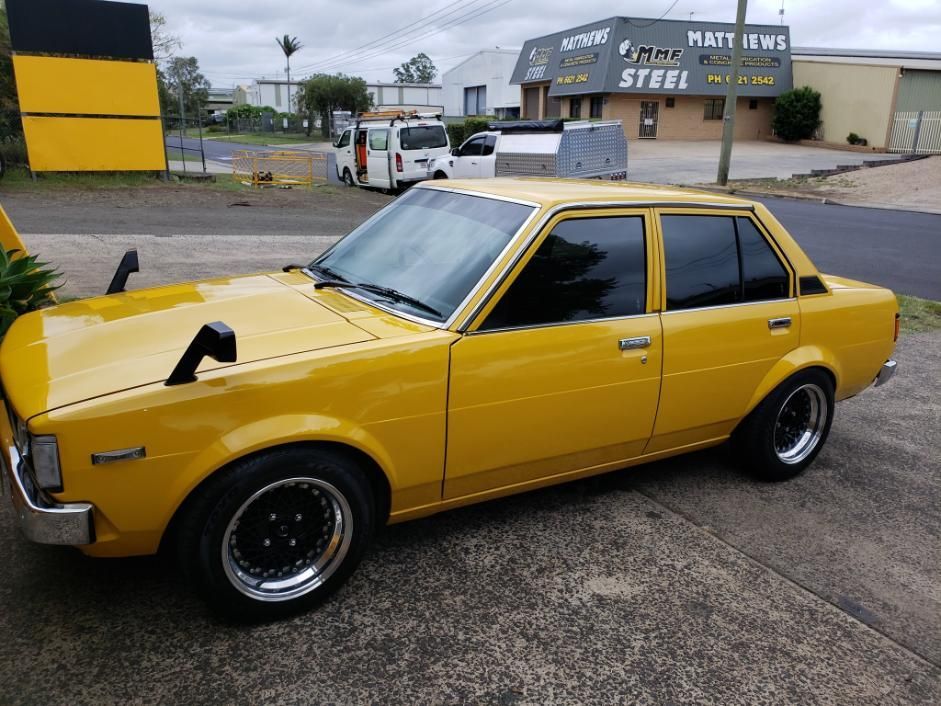 A Yellow Car Is Parked In Front Of A Building That Says Steel — Paint & Trade Supplies Lismore In Goonellabah, NSW