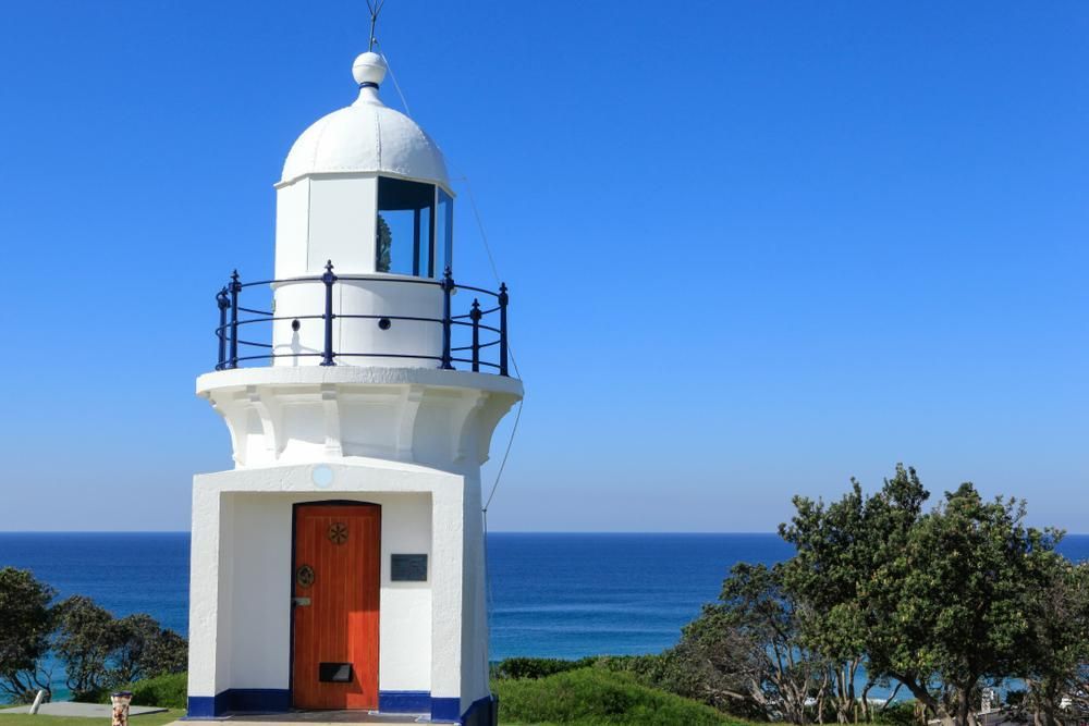 A White Lighthouse With A Red Door — Paint & Trade Supplies Lismore In Ballina, NSW