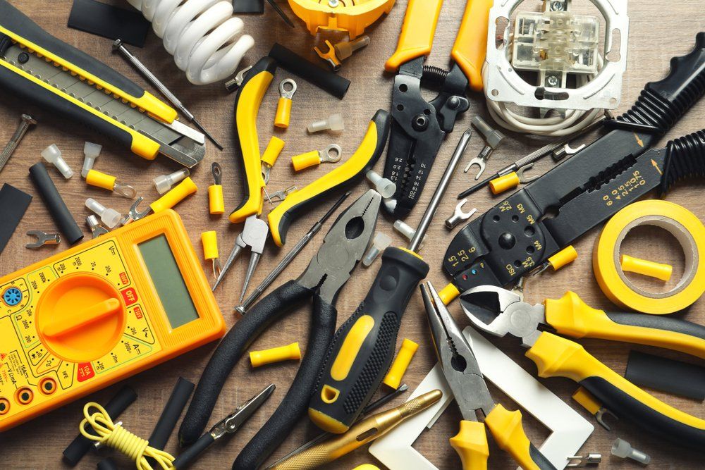 A Bunch of Yellow and Black Tools Are on a Wooden Table — Hennig Electrical Services in Caloundra, QLD