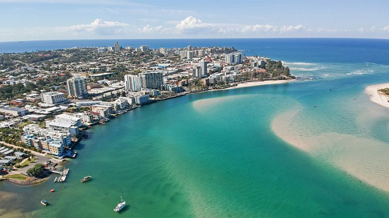 An Aerial View of a City Next to a Body of Water — Hennig Electrical Services in Caloundra, QLD