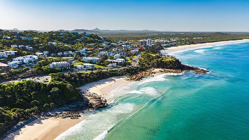 An Aerial View of a Beach With a City in the Background — Hennig Electrical Services in Noosa, QLD