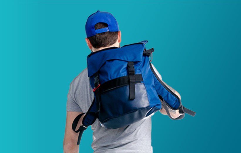 A man wearing a blue hat and carrying a blue backpack.