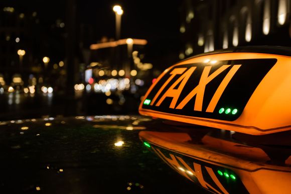 big taxi sign on background night