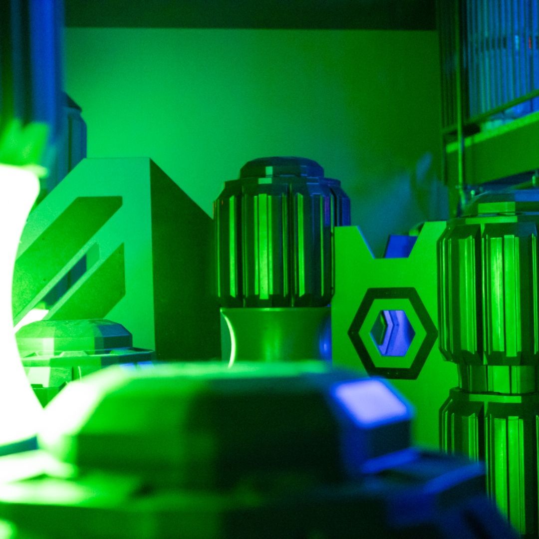 Abstract sci-fi construction in green and blue. Geometric shapes and cylindrical structures, futuristic.