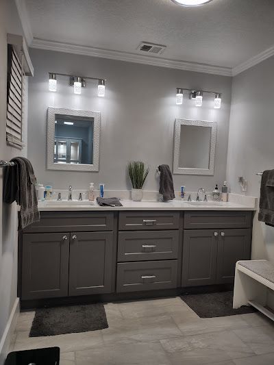 a bathroom with two sinks , a mirror and a bench