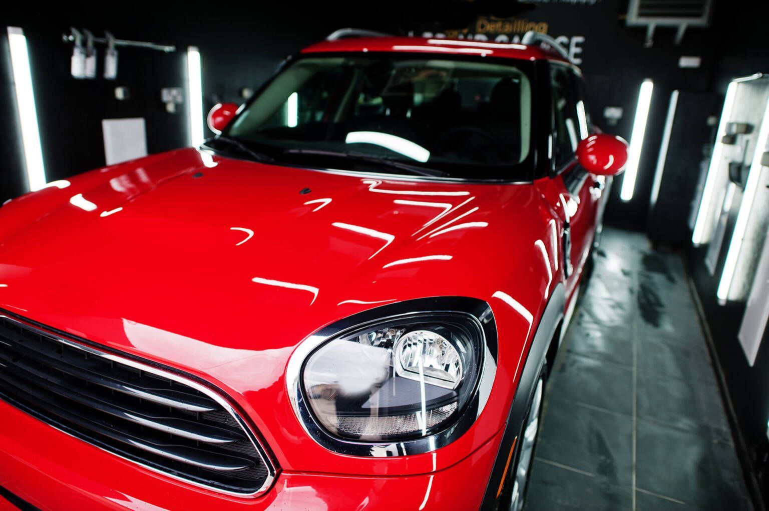 A red mini cooper is parked in a garage.