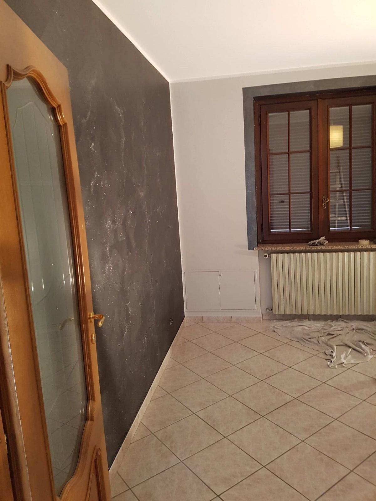 Una stanza vuota con una porta di legno e una finestra