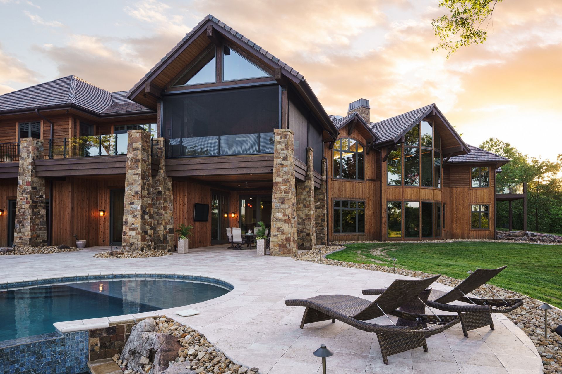 A large house with a swimming pool in front of it