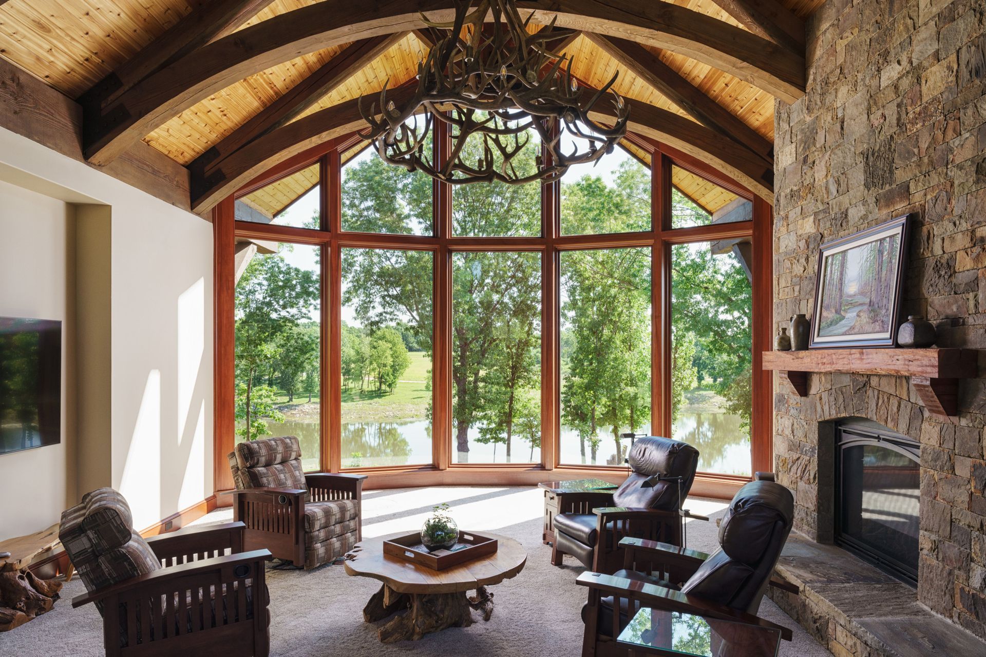 A living room with a fireplace and lots of windows