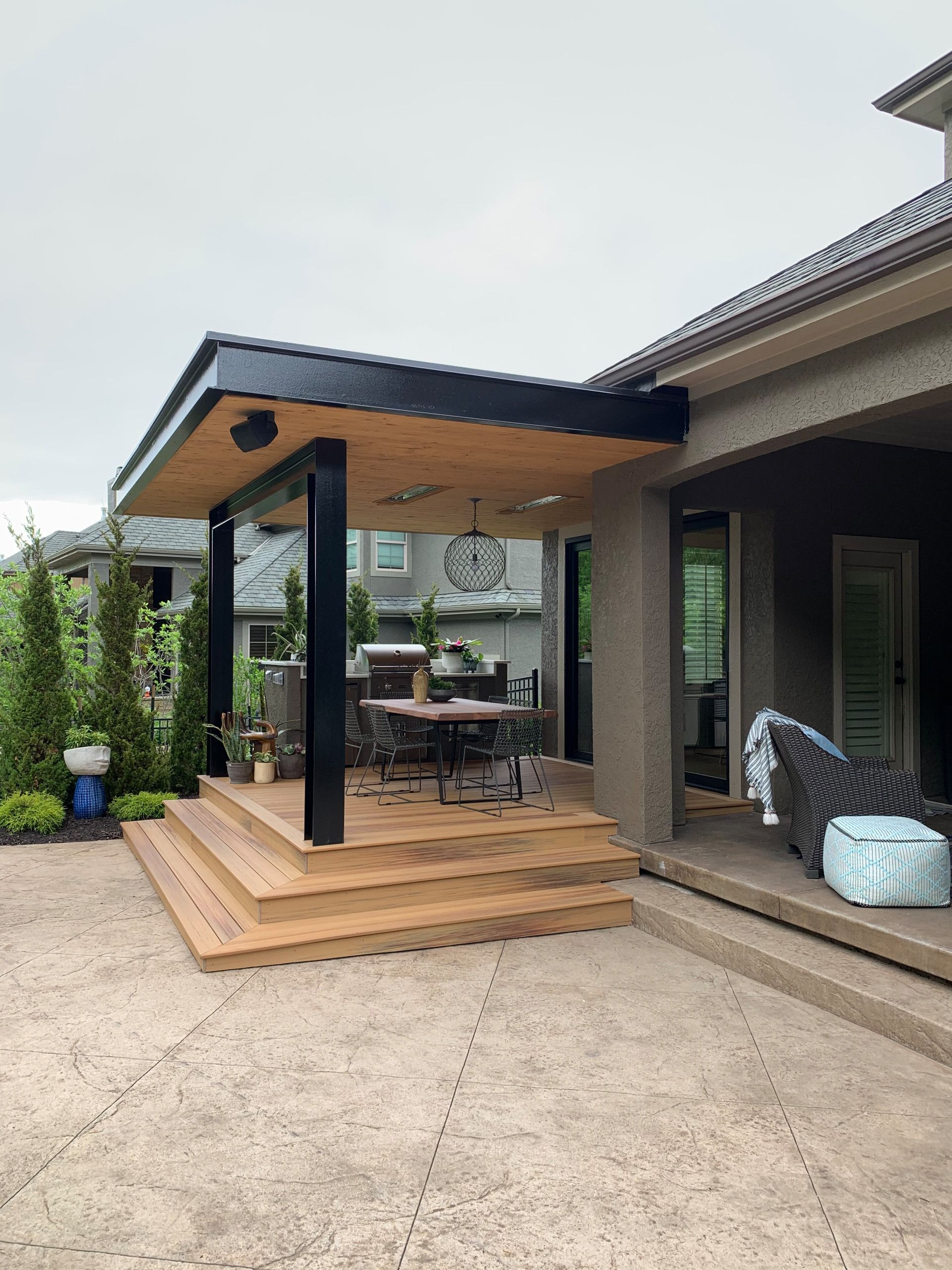 There is a covered patio with a table and chairs on it