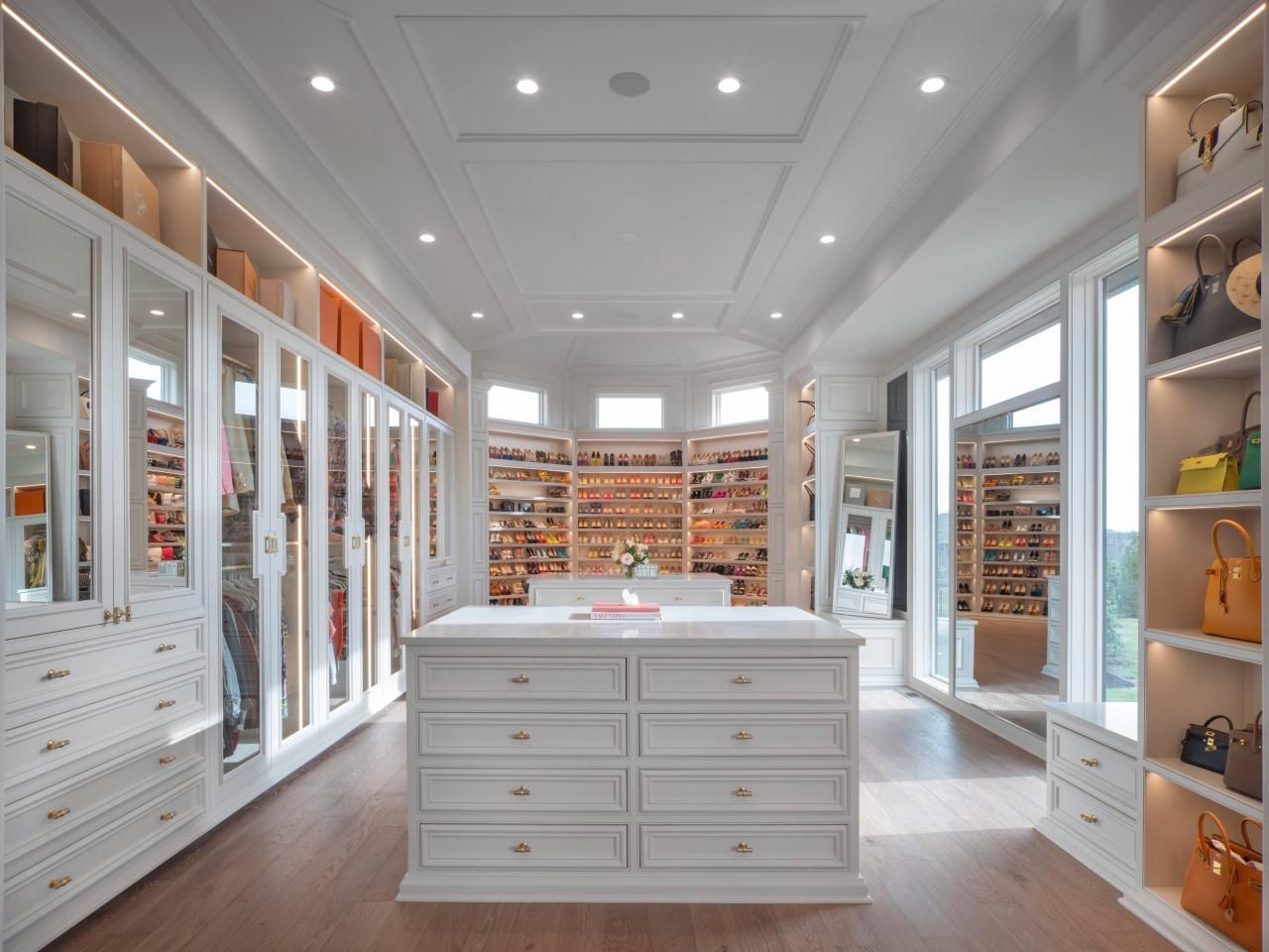 A kitchen with a bar and chairs and a wine rack