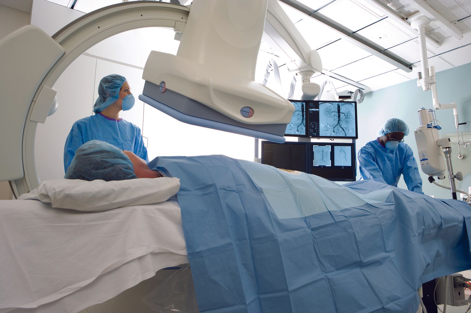 X-ray room with two doctors and patient 