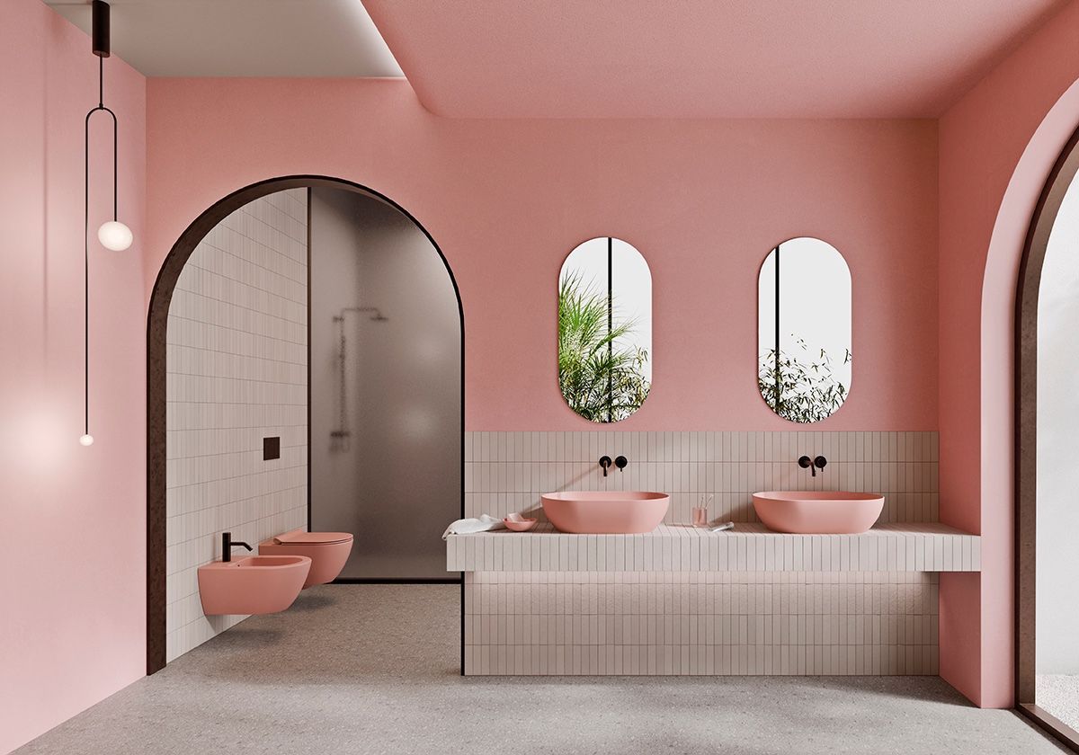 Bagno rosa con porte ad arco, due lavandini e zona doccia.