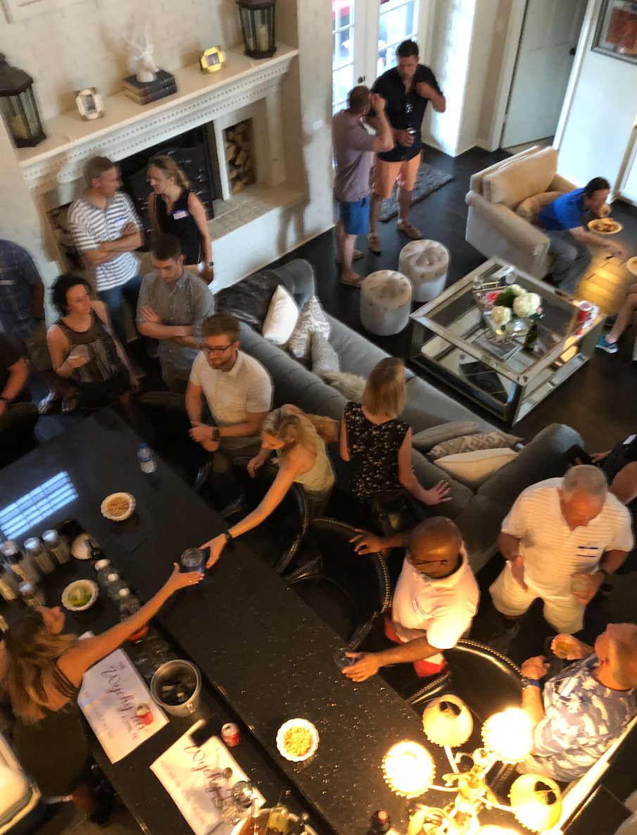A group of people are gathered in a living room