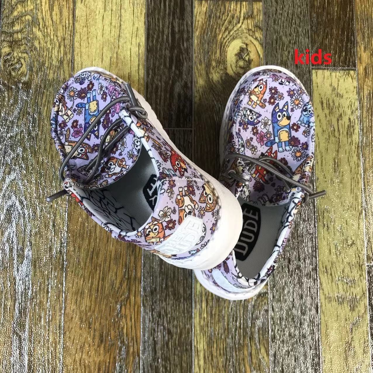 A pair of shoes are sitting on top of a wooden table.