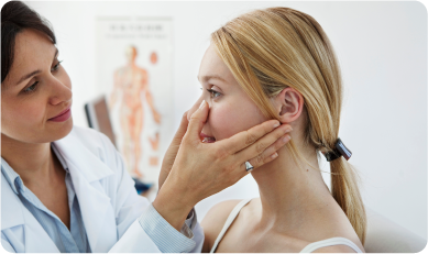 doctor examining the nose of a patient