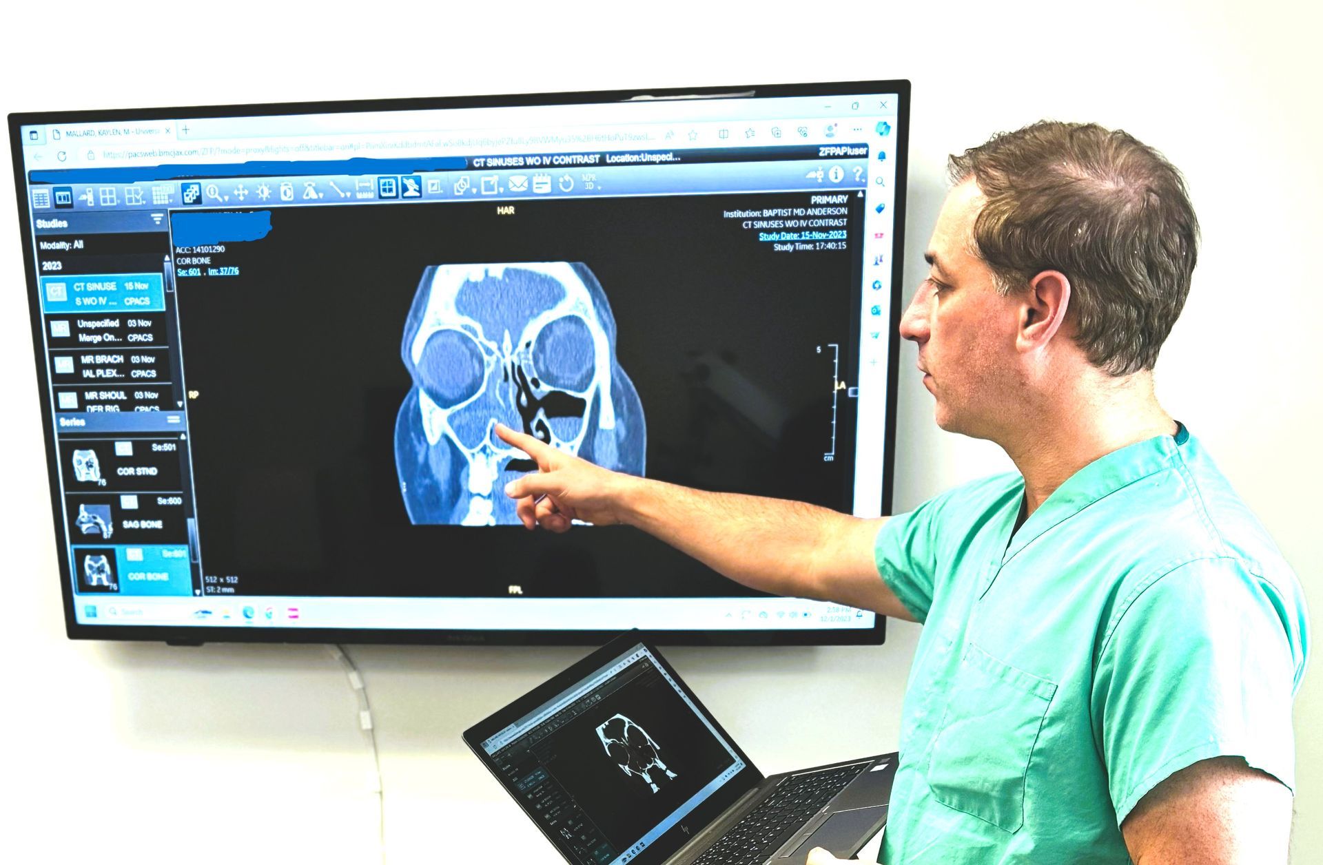 Dr. Farag looking at the CT of a patient with skull base issue.