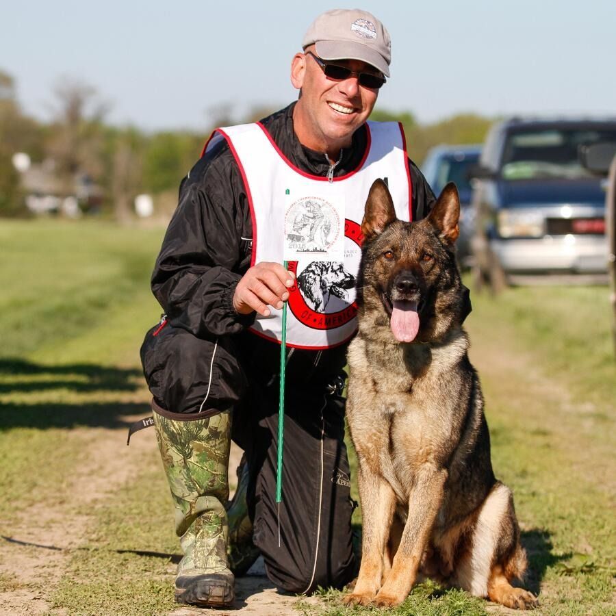 A man is next to a dog.