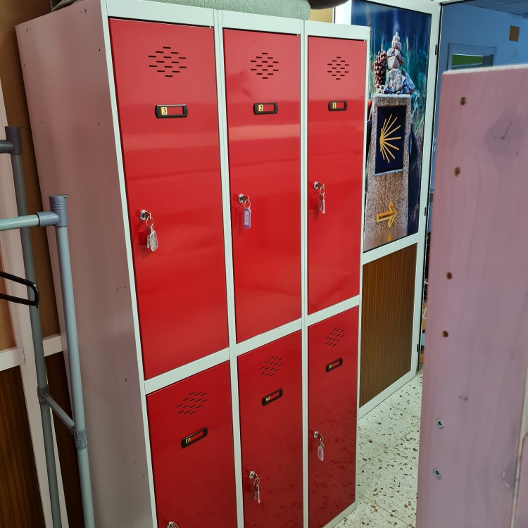A row of red lockers with keys on them