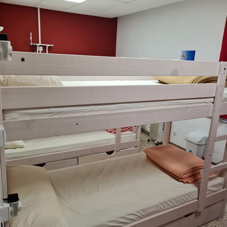 A bunk bed with two beds underneath it in a room