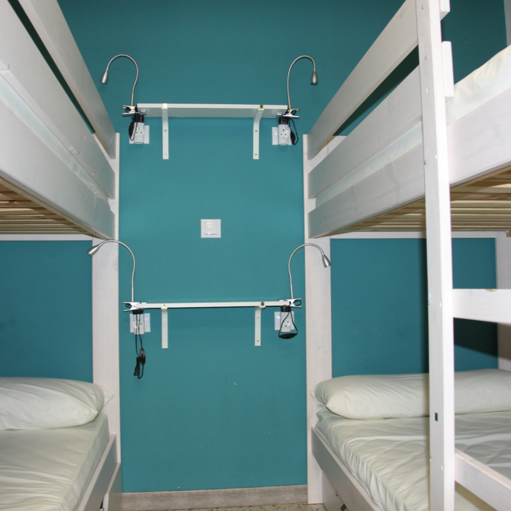A room with bunk beds and a blue wall