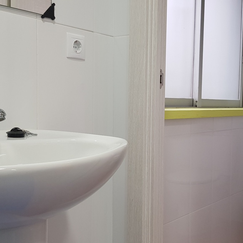 A bathroom with a sink and a window.