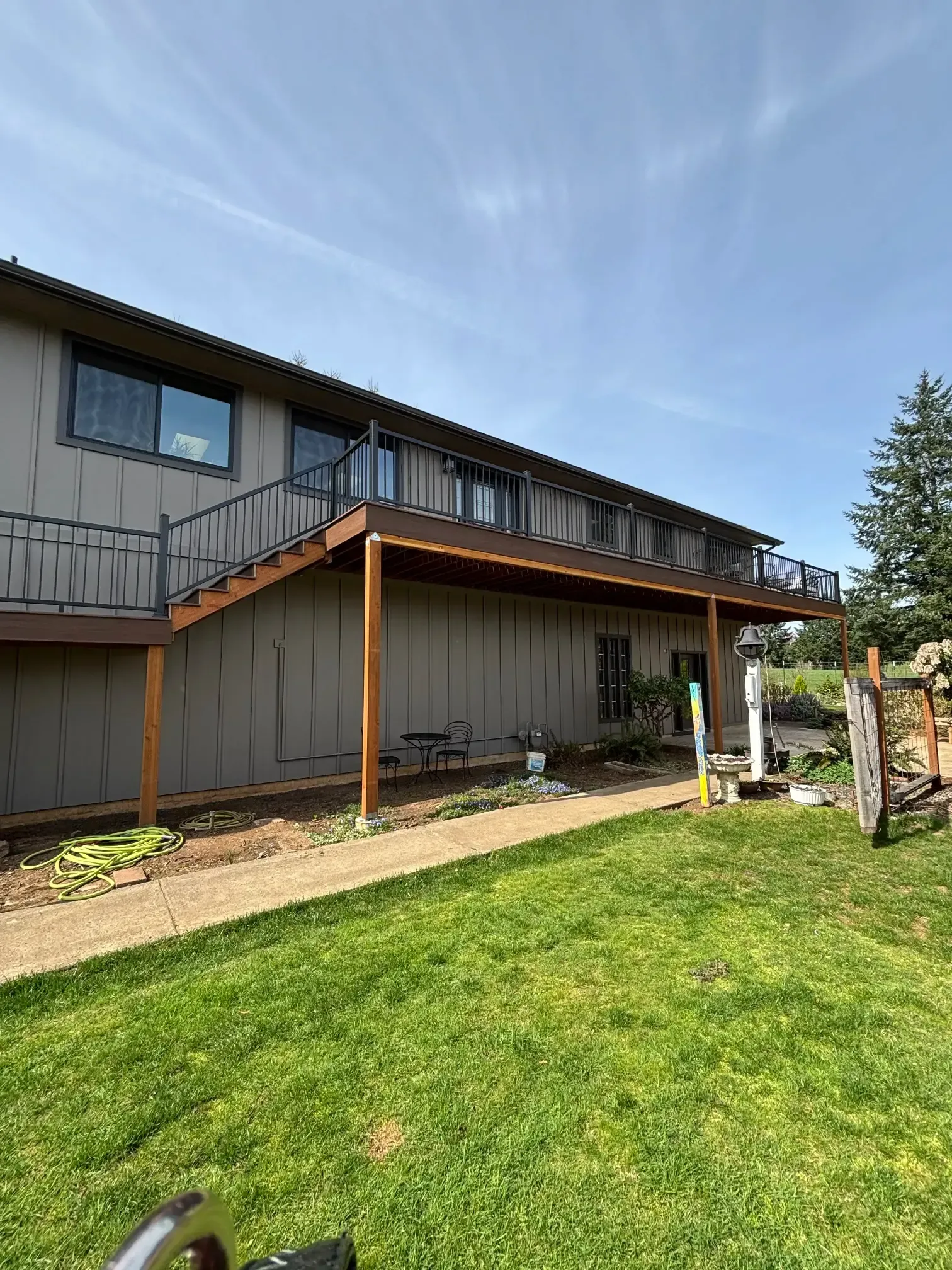 Wide shot of the entire back of the house and deck.