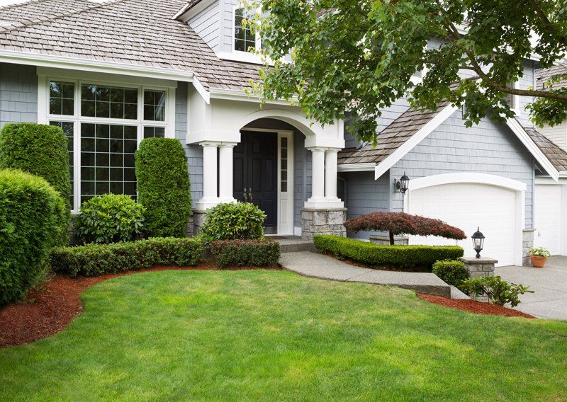 An exterior of a home with lush green grass outside