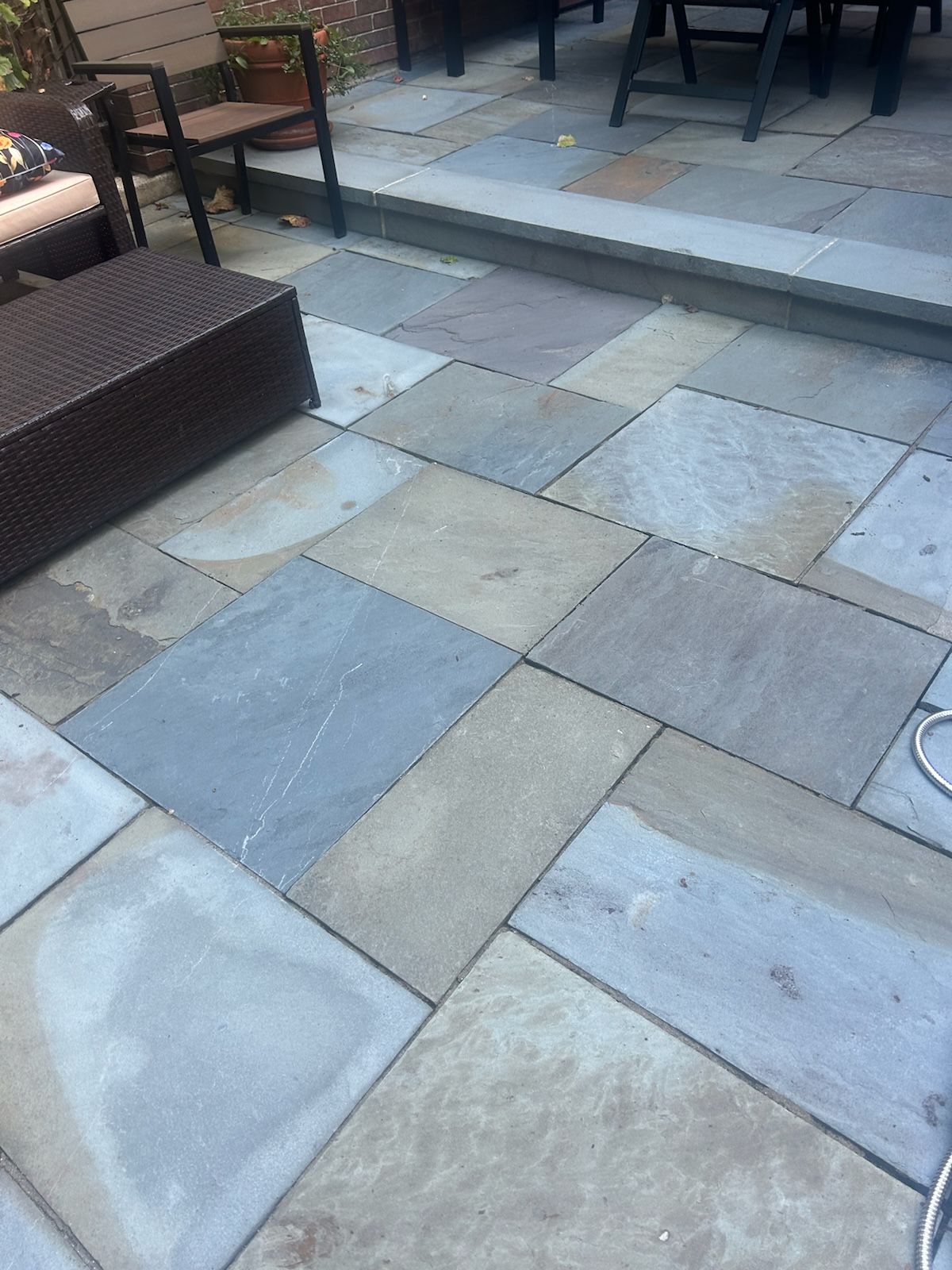 A patio with a lot of tiles and chairs on it