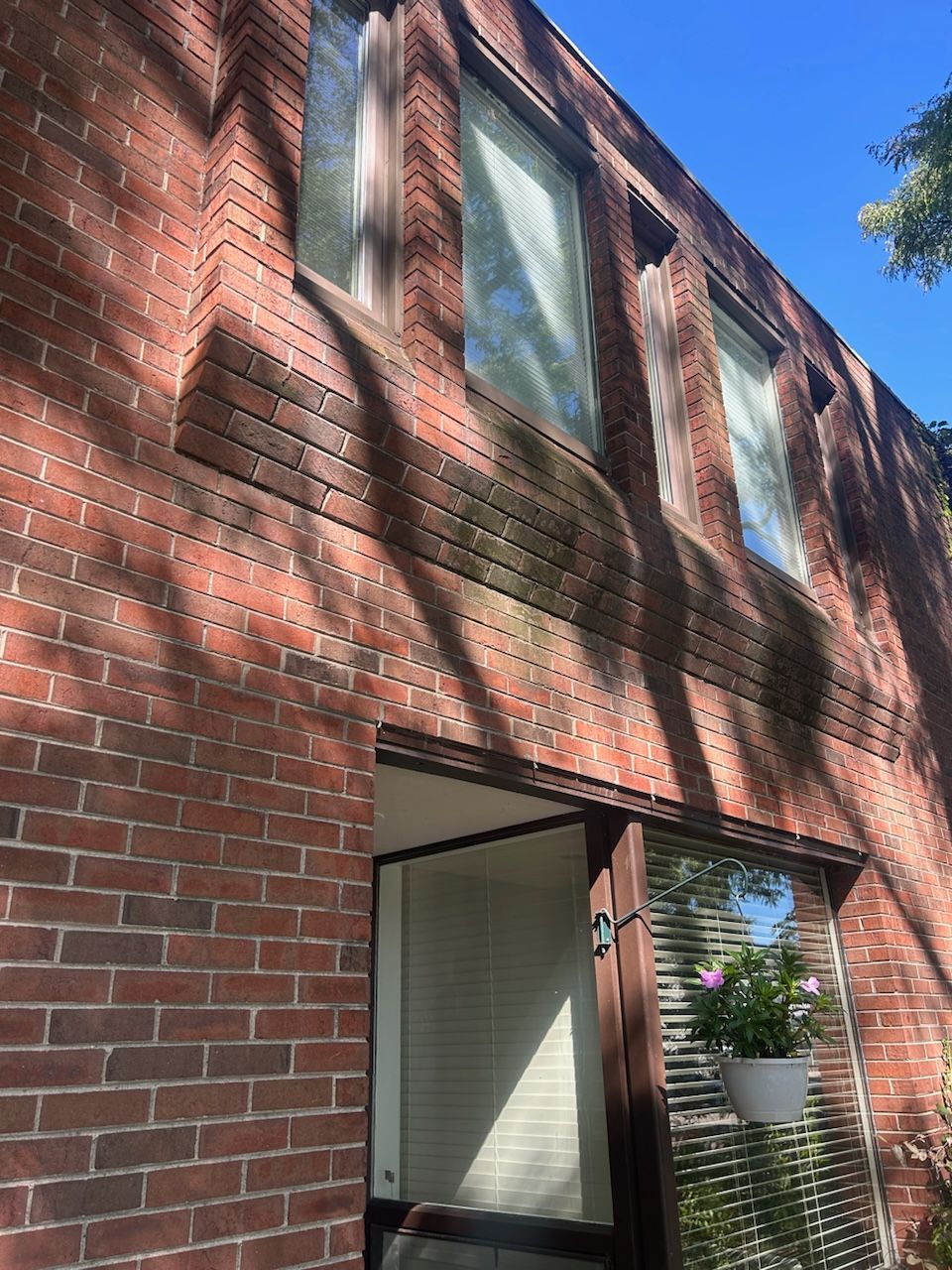 A brick building with a lot of windows and a door