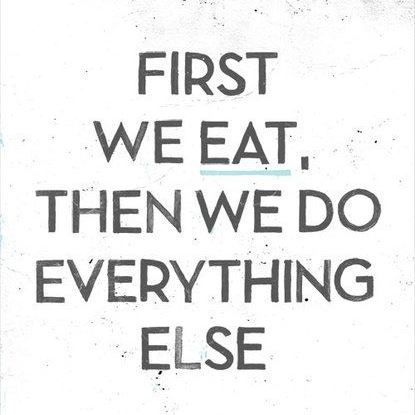 A poster that says `` first we eat , then we do everything else ''.