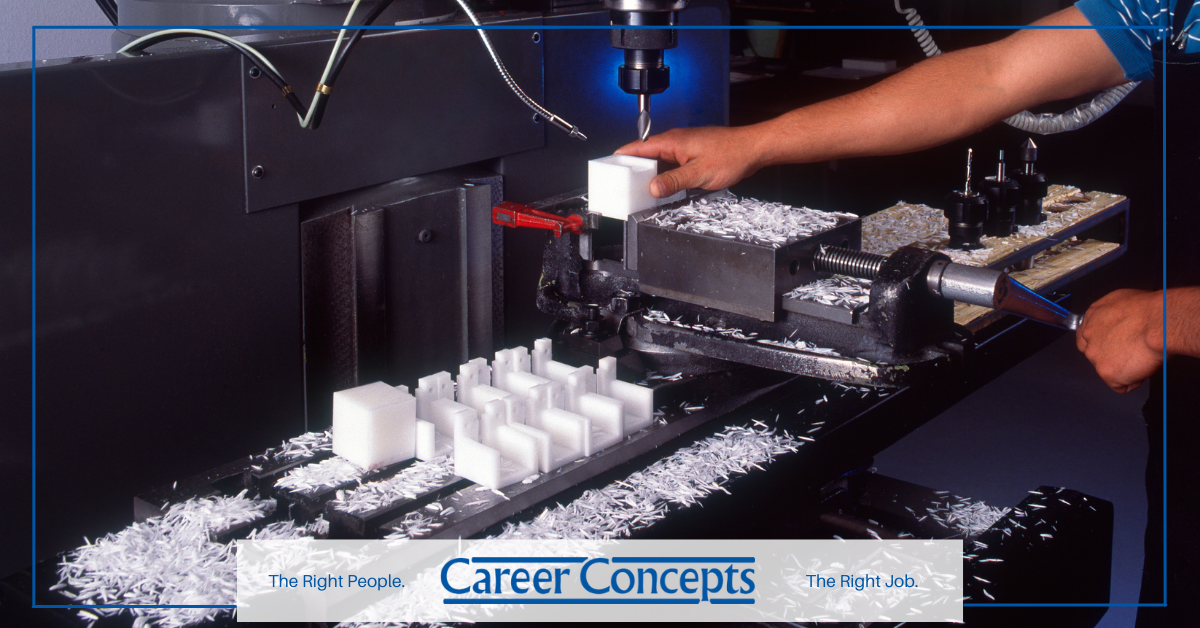 An employee using a plastics molding machine