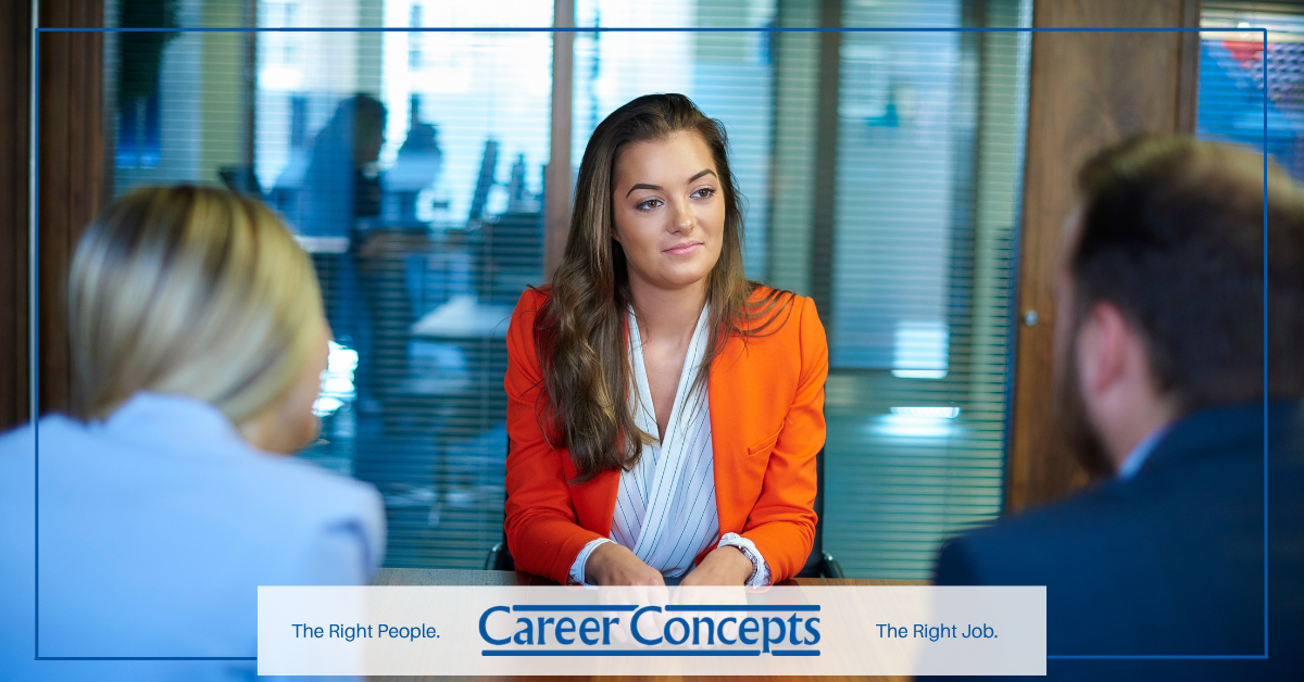 Confident job candidate participating in an interview with hiring managers.