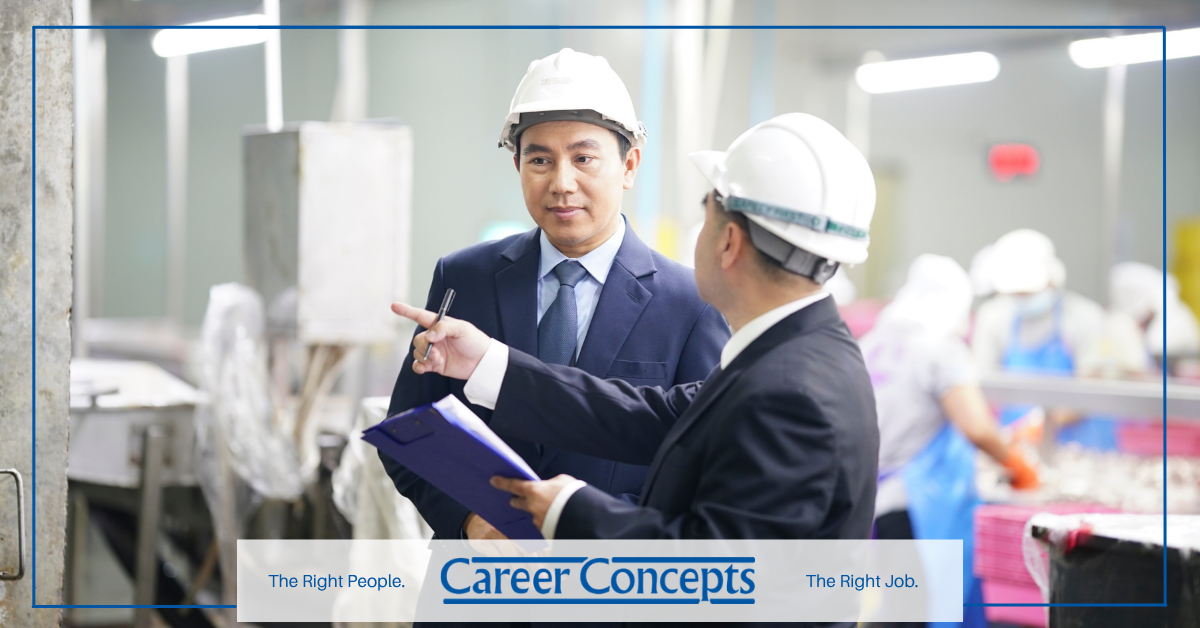 Two industrial manufacturing employees talking