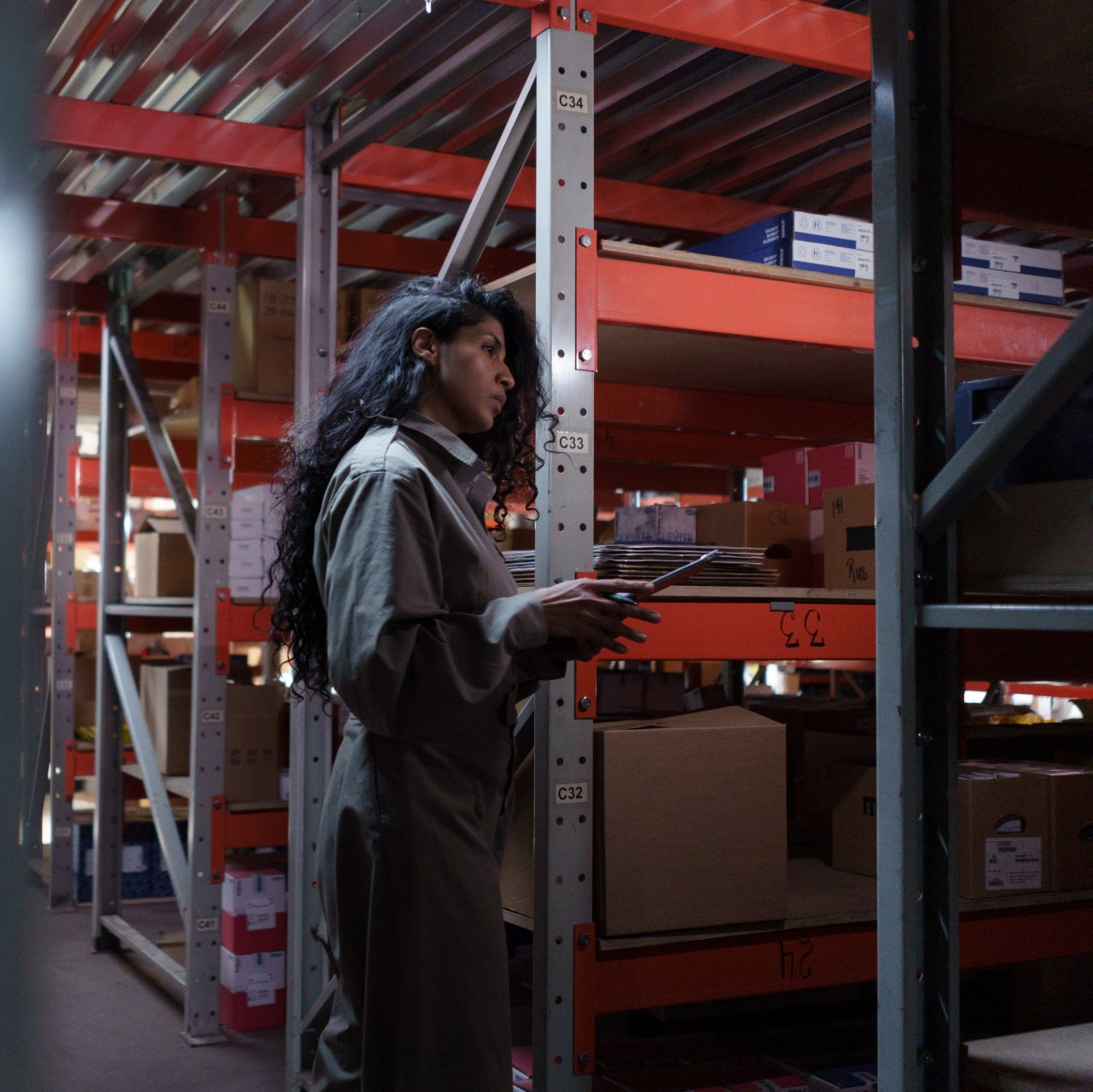 A warehouse worker taking stock