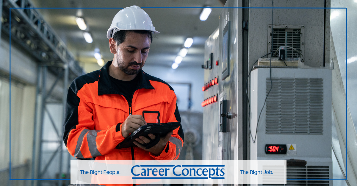 A light industrial employee looking at a tablet